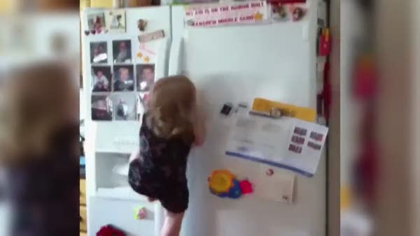 Çikolata için buzdolabına tırmanan minik kız